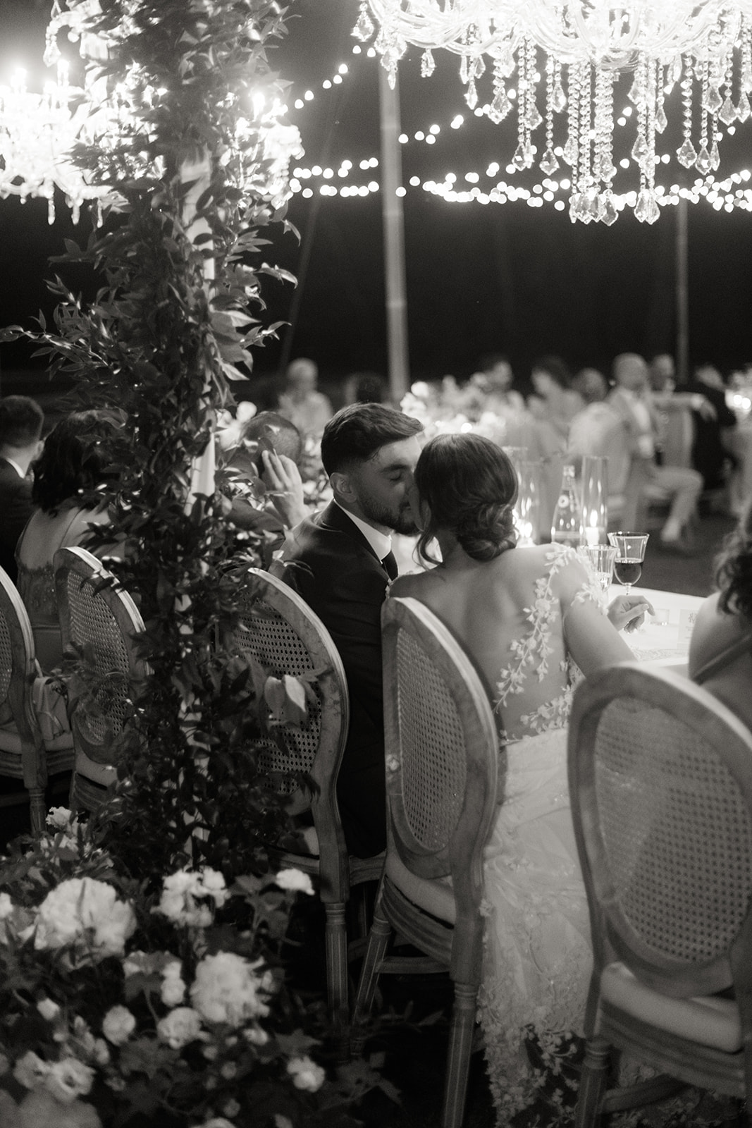 the bride and groom kiss at the table